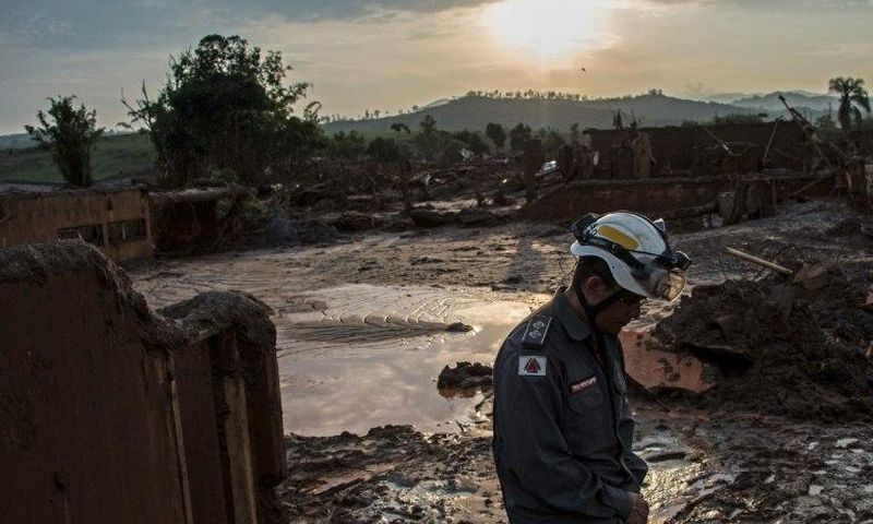 A firefighter walks in the mud in Bento Rodrigues, three days after an avalanche of mud and mining sludge buried the town in southeastern Brazil, on November 8, 2015