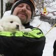 A picture from the Italian fire service on January 23, 2017 shows a fireman carrying a puppy found at the avalanche-hit Hotel Rigopiano