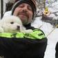 A picture from the Italian fire service on January 23, 2017 shows a fireman carrying a puppy found at the avalanche-hit Hotel Rigopiano