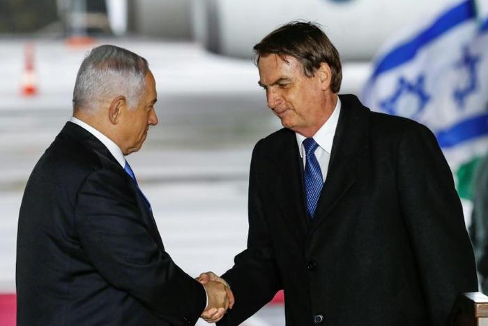 Brazilian President Jair Bolsonaro (R) was greeted on arrival in Israel by Prime Minister Benjamin Netanyahu