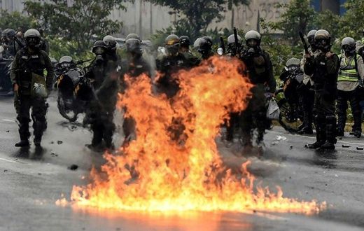 The Venezuelan National Guard stands guard as they clash with opposition activists clash in Caracas on April 13, 2017