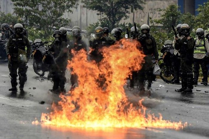 The Venezuelan National Guard stands guard as they clash with opposition activists clash in Caracas on April 13, 2017