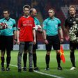 John Palmer (C), brother of Charlton Athletic season ticket holder, PC Keith Palmer, who was killed in the March 22, 2017 Westminster terror attack, greets match officials and players at The Valley Stadium in London