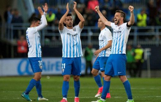 Malaga's players celebrates after winning 2-0 the Spanish league football match Malaga CF vs FC Barcelona at La Rosaleda stadium in Malaga on April 8, 2017