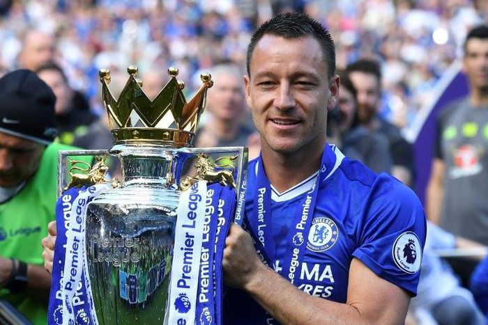 Chelsea's defender John Terry poses with the English Premier League trophy at Stamford Bridge in London on May 21, 2017