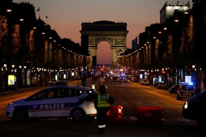 Police officers block the Champs Elysees boulevard in Paris after a shooting that left one police officer dead and another wounded on April 20, 2017