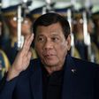 Philippine President Rodrigo Duterte walks past honour guards