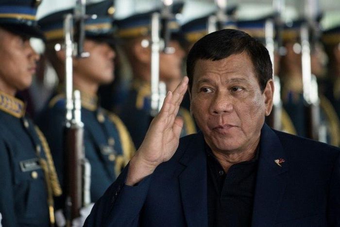 Philippine President Rodrigo Duterte walks past honour guards