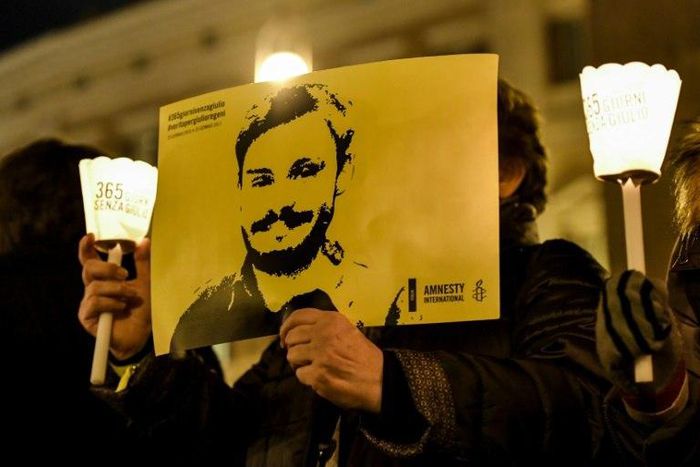 Activists of human rights organization Amnesty International hold a picture of Giulio Regeni and candles as they take part in a demonstration in front of Montecitorio, the Italian Parliament, in Rome on January 25, 2017