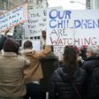 Anti-Trump protesters shout at supporters of US President Donald Trump during a rally near Trump Tower in Fifth Avenue, February 5, 2017 in New York