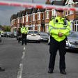 British police officers stand guard on April 28, 2017 in a residential area of north-west London, after a counter-terrorism raid during which officers shot Rizlaine Boular and arrested Khawla Barghouthi