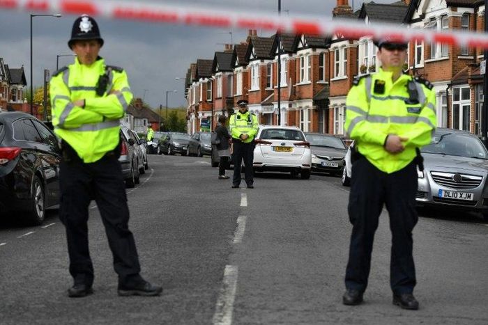 British police officers stand guard on April 28, 2017 in a residential area of north-west London, after a counter-terrorism raid during which officers shot Rizlaine Boular and arrested Khawla Barghouthi