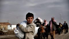 Residents of west Mosul flee the city on March 14, 2017, among more than 150,000 that have been displaced by the offensive government forces launched against the Islamic State group last month