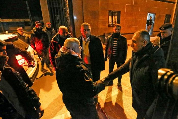 A member of the Palestinian Authority (R) shakes hands with Tawfiq Abu Naim (L), director general of the internal security forces in Gaza at the Rafah border crossing with Egypto, on January 7, 2019