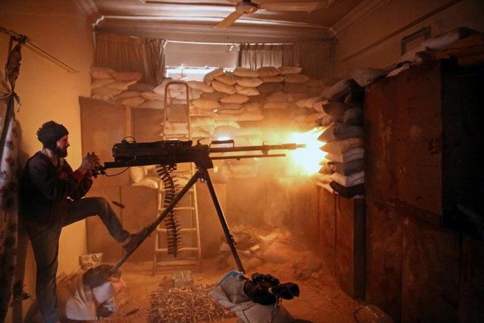 A Syrian opposition fighter fires a heavy machine gun in Jobar, a rebel-held district on the eastern outskirts of the Syrian capital Damascus, on March 19, 2017