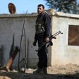 A fighter from Jaish al-Islam (Islam Army) rebel group stands guard in Bilaliyah, east Damascus, earlier this month