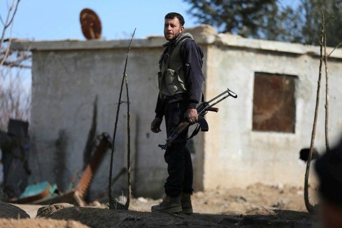 A fighter from Jaish al-Islam (Islam Army) rebel group stands guard in Bilaliyah, east Damascus, earlier this month