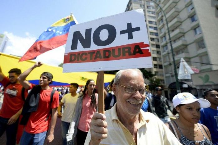 Venezuelan opposition activists shout slogans during a protest against the government of President Nicolas Maduro on April 6, 2017 in Caracas