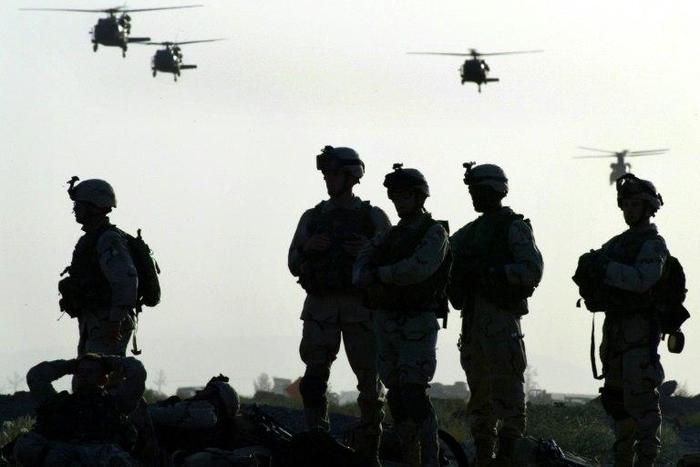 American soldiers wait to board helicopters at Kandahar airbase in Afghanistan in 2003
