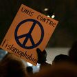 A person holds a sign "United against Islamophobia" during a rally near the Islamic Cultural Center in Quebec City, Canada on January 30, 2017