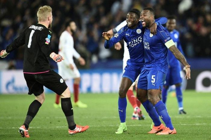 Leicester City's midfielder Wilfred Ndidi (C), defender Wes Morgan (R) and goalkeeper Kasper Schmeichel (L) celebrate their victory at the final whistle during the UEFA Champions League football match against Sevilla March 14, 2017