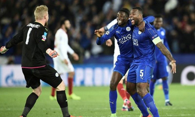Leicester City's midfielder Wilfred Ndidi (C), defender Wes Morgan (R) and goalkeeper Kasper Schmeichel (L) celebrate their victory at the final whistle during the UEFA Champions League football match against Sevilla March 14, 2017