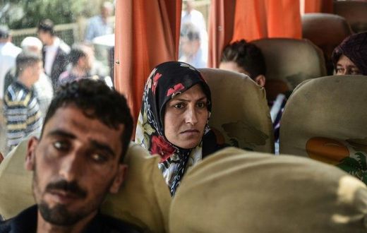 Syrian victims of a suspected chemical attack are carried in a bus back to the Syrian border after treatment in Turkey on April 7, 2017