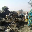 Survivors look at the aftermath of the bombing by the Nigerian air force of a camp for displaced people in Rann, northeast Nigeria, on January 17, 2017