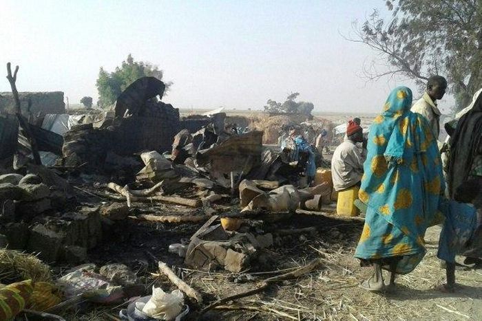 Survivors look at the aftermath of the bombing by the Nigerian air force of a camp for displaced people in Rann, northeast Nigeria, on January 17, 2017