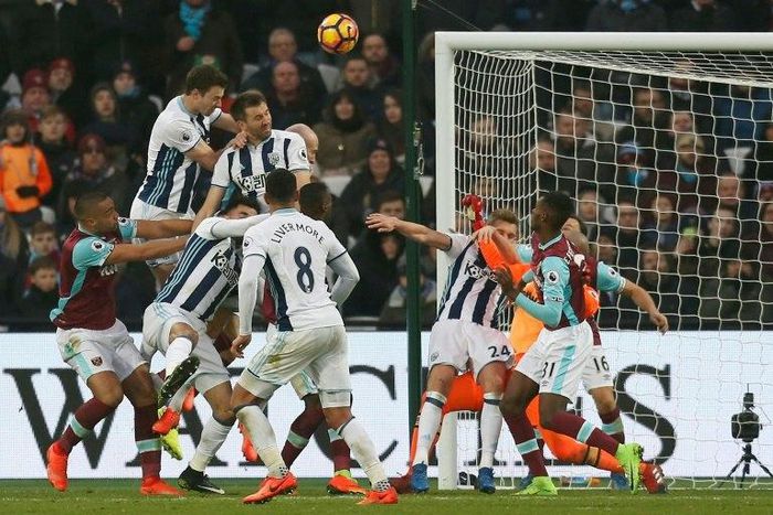 West Bromwich Albion's defender Gareth McAuley (4th L) jumps to head their late equalizer during their match against West Ham United at The London Stadium, in east London on February 11, 2017