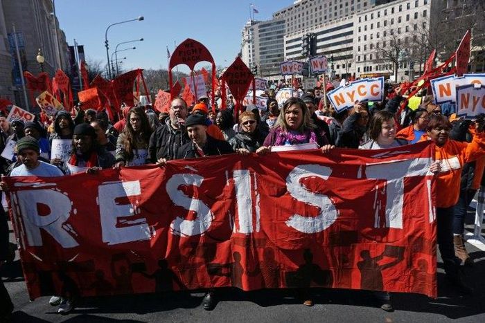 Health care activists march to the Trump International hotel in Washington, DC, during a protest against President Donald Trump's effort to repeal Obamacare