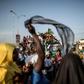 Supporters of Adama Barrow, flag-bearer of the coalition of the seven opposition political parties in Gambia, gather in the streets of Talinding on the outskirts of Banjul on November 25, 2016 to try to catch a glimpse of the candidate's motorcade