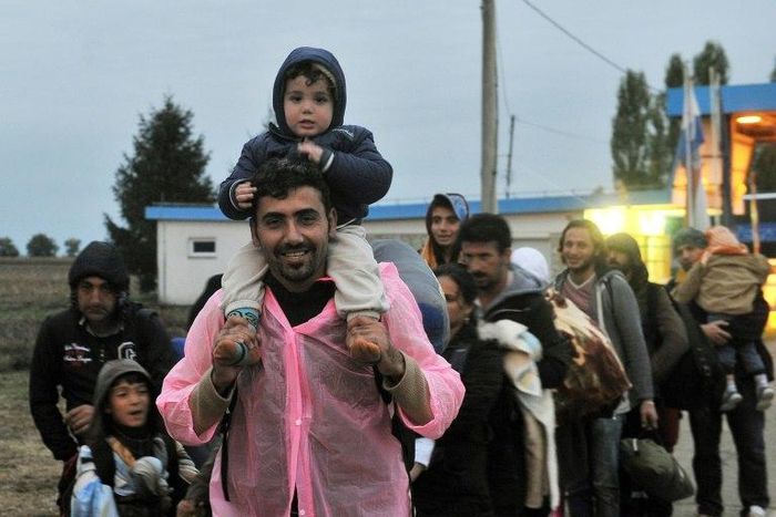 A group of Middle-Eastern migrants walk before crossing the Croatian-Hungarian border in the village of Baranjsko Petrovo Selo, near North-Eastern Croatian town of Beli Manastir, on September 29, 2015