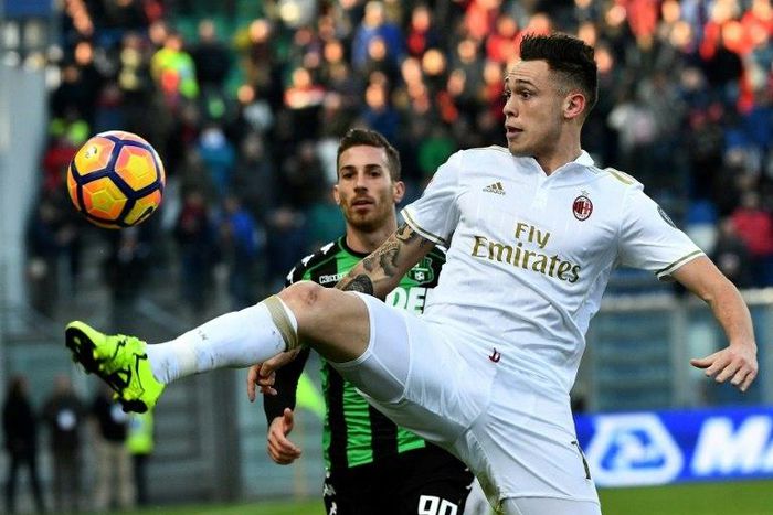 AC Milan's forward Lucas Ocampos controls the ball over Sassuolo's forward Antonino Ragusa (rear) during the Italian Serie A match Sassuolo vs AC Milan at the Mapei stadium in Reggio Emilia on February 26, 2017