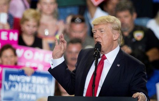 US President Donald Trump (C) speaks during a rally in Harrisburg, Pennsylvania marking his 100th day in office