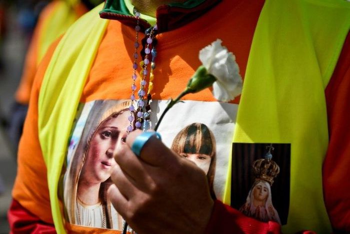 A pilgrim sports a T-shirt with the image of Our Lady of Fatima ahead of a visit by Pope Francis to the shrine in central Portugal