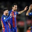 Barcelona's Lionel Messi (L) celebrates with Sergio Busquets (C) and Luis Suarez after scoring during their match against Sporting de Gijon at the Camp Nou stadium in Barcelona on March 1, 2017