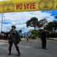 Colombian security forces stand guard outside a police cadet training academy in Bogota, the site of a deadly car bomb attack blamed on ELN rebels