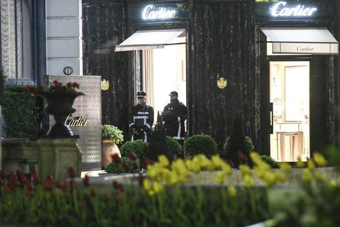 Police officers stand guard in front of the Cartier jewellery boutique after it was robbed in downtown Monaco