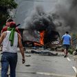 Venezuelan opposition activists set up barricades during a demonstration against President Nicolas Maduro, in San Cristobal, on April 24, 2017