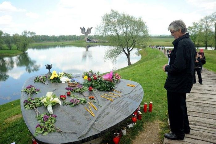 A man looks at the World War II Jasenovac memorial camp model on April 26, 2015, during a ceremony to remember the tens of thousands who were killed by the country's pro-Nazi regime