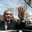 Turkish President Recep Tayyip Erdogan (L) greeting supporters during his visit to the Eyup Sultan Mosque in Istanbul the day after his victory in a national referendum on April 17, 2017