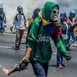Venezuelan opposition activists clash with riot police during a protest march against President Nicolas Maduro in Caracas on April 26, 2017