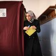 A woman walks to the ballot box to place her vote in the referendum on expanding the powers of the Turkish president on April 16, 2017 in Istanbul