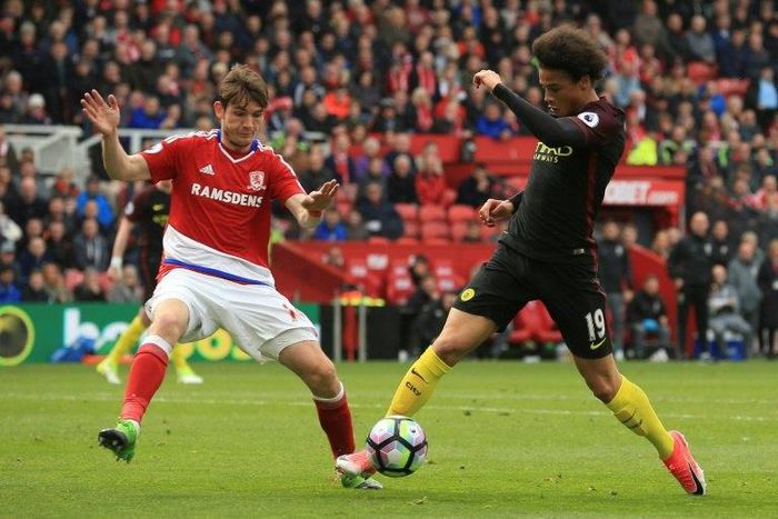 Middlesbrough's midfielder Marten de Roon (L) challenges Manchester City's midfielder Leroy Sane on April 30, 2017