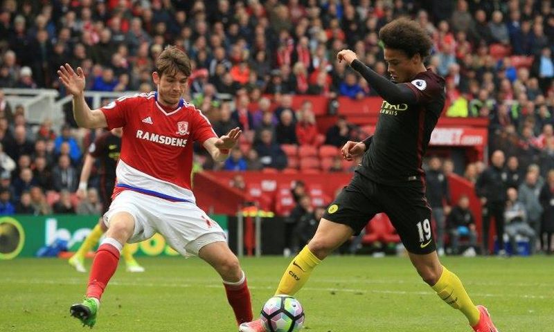 Middlesbrough's midfielder Marten de Roon (L) challenges Manchester City's midfielder Leroy Sane on April 30, 2017