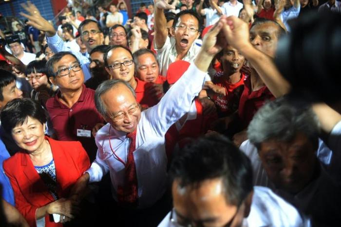 Singaporean presidential candidate Tan Cheng Bock (2nd-L) greeting his supporters in 2011 when he stood as candidate of the presidential elections in Singapore