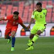 Chile's Alexis Sanchez (L) fights for the ball with Venezuela's Renzo Zambrano during their Russia 2018 World Cup qualifier match, in Santiago, on March 28, 2017