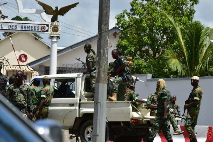 Rebellious soldiers near the entrance of Ivory Coast's army headquarters are demanding the rest of promised back pay