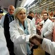The atmosphere was cordial for the most part during Le Pen's visit to Europe's biggest wholesale fresh food market, but she also drew boos